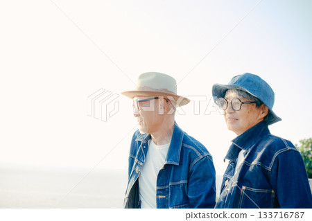 Senior couple enjoying a conversation at the beach Senior couple enjoying a conversation at the beach 133716787