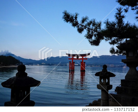 A fantastical view of a torii gate floating in the morning sea A fantastical view of a torii gate floating in the morning sea 133717152