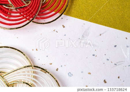 A composition of Mizuhiki decorations placed on white Japanese paper and a gold backing 133718624