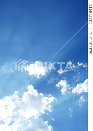 vertical image. Bright blue sky with soft white clouds, cloudscape background. vertical image. Bright blue sky with soft white clouds, cloudscape background. 133719416