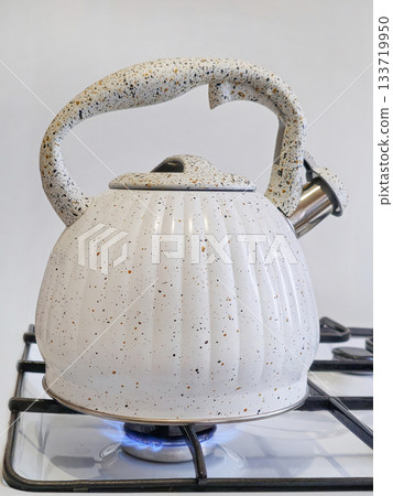 new white kettle on the gas stove new white kettle on the gas stove 133719950