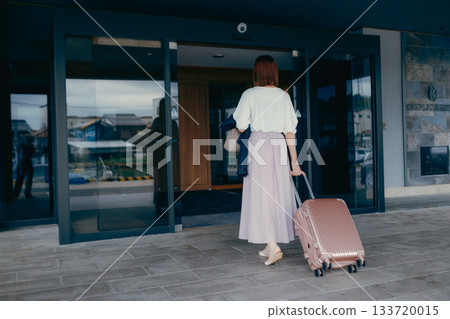 Female traveler arriving at hotel Female traveler arriving at hotel 133720015