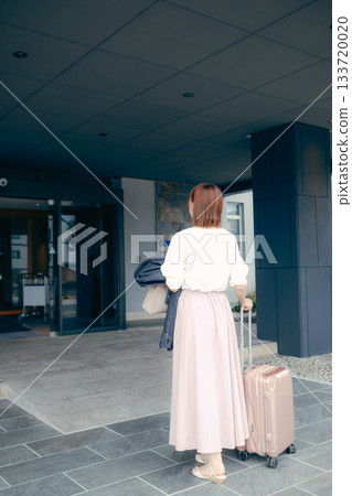 Female traveler arriving at hotel 133720020