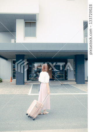 Female traveler arriving at hotel 133720028