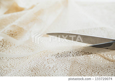 Cutting lace fabric with scissors Cutting lace fabric with scissors 133720074