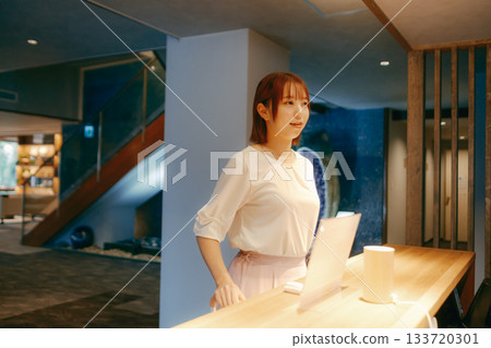 A woman in her twenties checking in with her smartphone 133720301