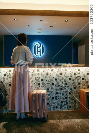 A woman in her twenties checking in with her smartphone 133720306