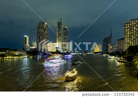Night view and boats on the Chao Phraya River in Bangkok, Thailand 133720342