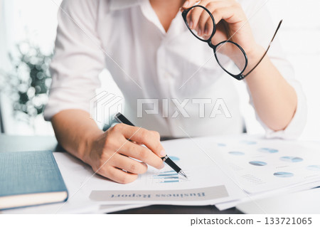 Business woman analyze calculate company financial, tax results office accounting statistics analytical research. calculating business balance prepare tax reduction. Tax deduction planning concept. Business woman analyze calculate company financial, tax results office accounting statistics analytical research. calculating business balance prepare tax reduction. Tax deduction planning concept. 133721065