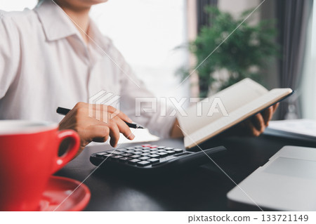 Business woman analyze calculate company financial, tax results office accounting statistics analytical research. calculating business balance prepare tax reduction. Tax deduction planning concept. Business woman analyze calculate company financial, tax results office accounting statistics analytical research. calculating business balance prepare tax reduction. Tax deduction planning concept. 133721149