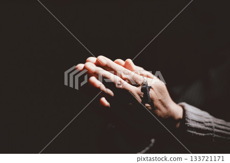 Person holding hands together in prayer gesture, symbolizing hope, faith, meditation, spirituality, trust, belief, peace, devotion, inner strength and resilience during hard times. Person holding hands together in prayer gesture, symbolizing hope, faith, meditation, spirituality, trust, belief, peace, devotion, inner strength and resilience during hard times. 133721171