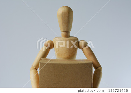 Drawing doll holding cardboard 133721426