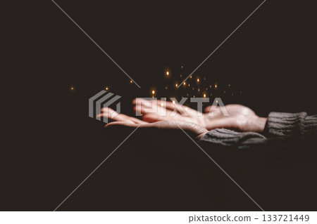 Hands holding glowing light, symbolizing hope, healing, faith, inspiration, spiritual energy, new beginning, miracle, inner strength and positive transformation from darkness to light. 133721449