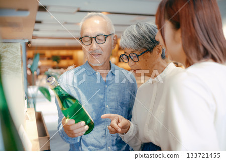 一家三口在飯店店挑選紀念品的場景 133721455