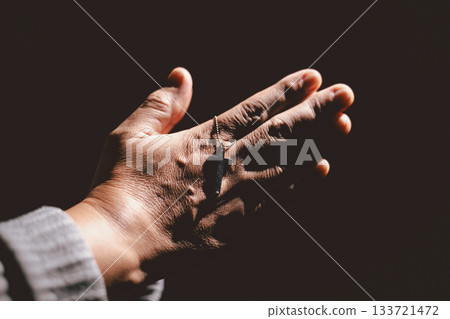 Person holding hands together in prayer gesture, symbolizing hope, faith, meditation, spirituality, trust, belief, peace, devotion, inner strength and resilience during hard times. Person holding hands together in prayer gesture, symbolizing hope, faith, meditation, spirituality, trust, belief, peace, devotion, inner strength and resilience during hard times. 133721472