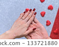 a woman's hand in a man's hand. 133721880