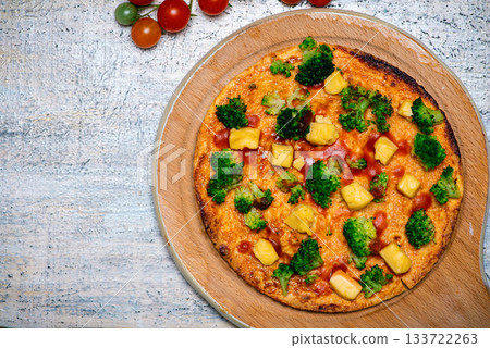 Freshly Baked Broccoli Pizza Served on a Wooden Pizza Board 133722263