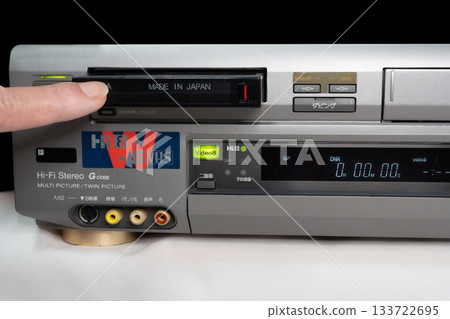 A scene of inserting a tape into a worn Hi8 VCR 133722695