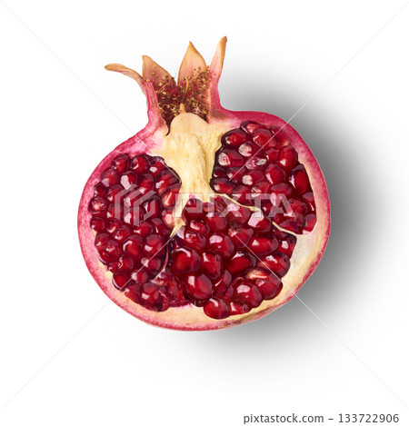 Flying in air fresh ripe whole and cut pomegranate with seeds and leaves isolated. High resolution image Flying in air fresh ripe whole and cut pomegranate with seeds and leaves isolated. High resolution image 133722906