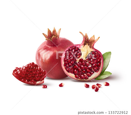 Flying in air fresh ripe whole and cut pomegranate with seeds and leaves isolated. High resolution image Flying in air fresh ripe whole and cut pomegranate with seeds and leaves isolated. High resolution image 133722912