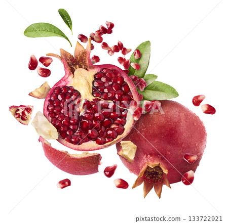 Flying in air fresh ripe whole and cut pomegranate with seeds and leaves isolated. High resolution image Flying in air fresh ripe whole and cut pomegranate with seeds and leaves isolated. High resolution image 133722921
