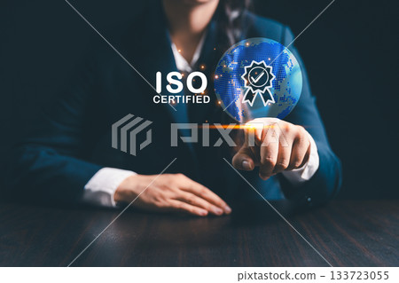 Businesswoman stands beside globe, representing modern global business practices where ISO standards, quality control, certification ensure product quality assurance, guarantee across market. Businesswoman stands beside globe, representing modern global business practices where ISO standards, quality control, certification ensure product quality assurance, guarantee across market. 133723055