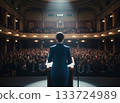 A female leader giving a speech in front of a large audience 133724989