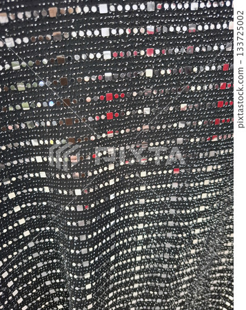 This textile features a metallic sequin knit texture, showcasing shiny reflective elements that create a striking visual appeal, ideal for stylish garments or decorative items. 133725002