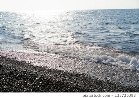 Relax by the smooth pebbled beach with gentle waves lapping against the shore. This luxurious spa offers stunning sea views and invites tranquility in a perfect setting. Relax by the smooth pebbled beach with gentle waves lapping against the shore. This luxurious spa offers stunning sea views and invites tranquility in a perfect setting. 133726398