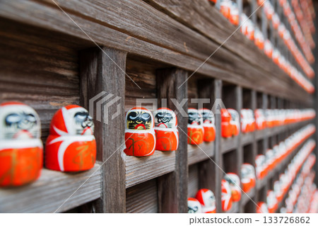 small daruma figurines decor on wooden wall in Katsuoji temple, Osaka 133726862
