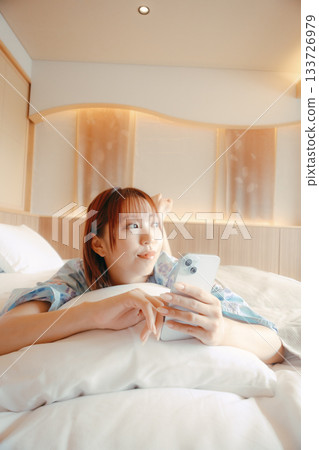A scene of a woman in a yukata relaxing on a bed A scene of a woman in a yukata relaxing on a bed 133726979