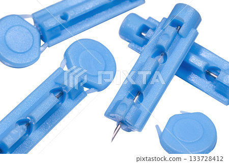 Blue disposable sterile lancets for blood draw close up Blue disposable sterile lancets for blood draw close up 133728412