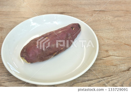 grilled Japanese purple yam with peel arranging on plate  133729091