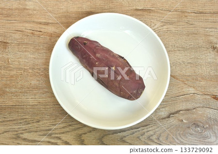 grilled Japanese purple yam with peel arranging on plate  133729092