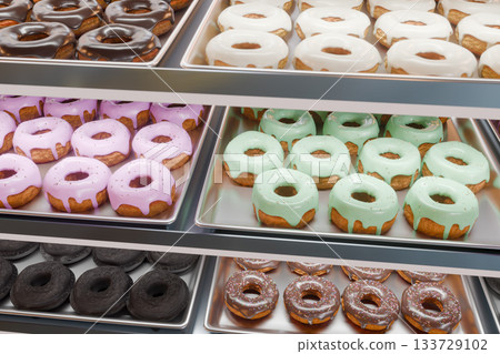 Colorful donuts lined up on a tray Colorful donuts lined up on a tray 133729102