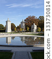 Monument and autumn trees reflected in the pond 133730814