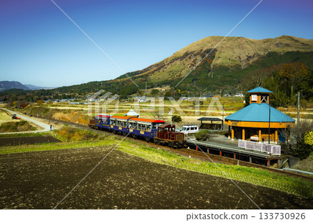 Autumn trolley train running through Minamiaso Autumn trolley train running through Minamiaso 133730926