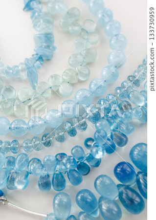 Natural aquamarine beads — a beautiful, clear blue jewelry material 133730959