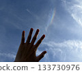 An illusion of hands stretched out to the sky and clouds 133730976