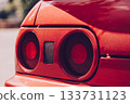 A bright red sports car, seen from the rear, with large round taillights. A stylish retro feel and a strong emphasis on the car's design. Car racing, street racing. 133731123