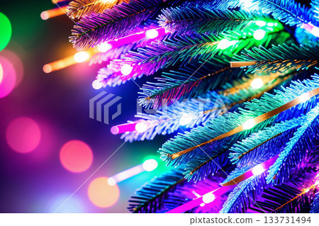 Christmas tree branches with colorful lights and bokeh are a beautiful background for the New Year holiday 133731494