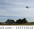A passenger plane ascending while turning and a park 133731618