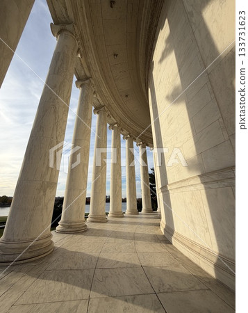 The marble corridor of the temple bathed in the setting sun 133731623