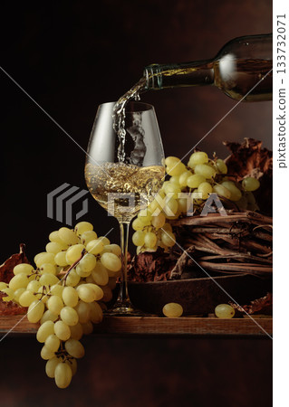 Wine is poured into a glass. Wine is poured into a glass. 133732071