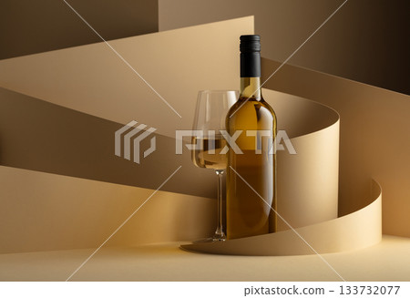 Bottle and glass of white wine on a beige background. Bottle and glass of white wine on a beige background. 133732077