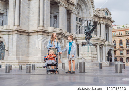 Mother tourist with her two sons in front of Palacio de Bellas Artes in Mexico City, enjoying family travel, architecture, and cultural heritage. Family travel and bonding concept 133732510