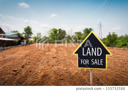 land for sale sign against trimmed lawn background. Empty dry cracked swamp reclamation soil, land plot for housing construction land for sale sign against trimmed lawn background. Empty dry cracked swamp reclamation soil, land plot for housing construction 133732588