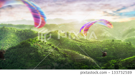Paragliding multicolor. Paraglider flying over Landscape from the background Beauty nature mountain landscape of the sky. 133732589