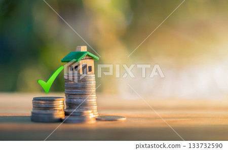 Mortgage and loan approved concept: house on a coin pile. planning savings money of coins to buy a home Mortgage and loan approved concept: house on a coin pile. planning savings money of coins to buy a home 133732590