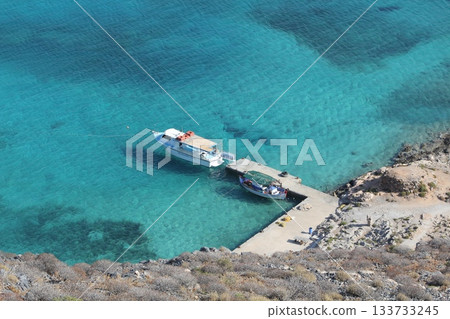 Boat at the pier top view, clear blue water in Greece, near the rocks 133733245